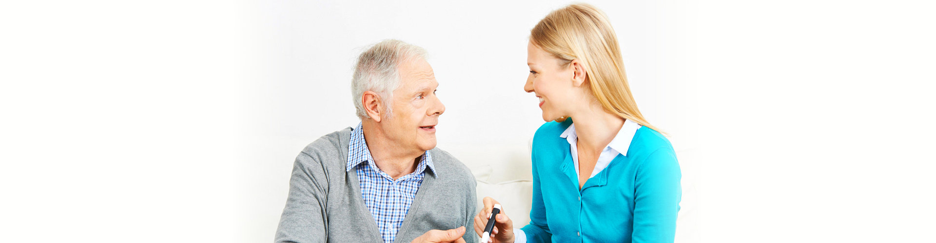 elderly man and caretaker talking each other